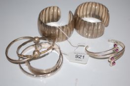 A collection of 7 20th century and vintage ladies silver and white metal bangles to include ball