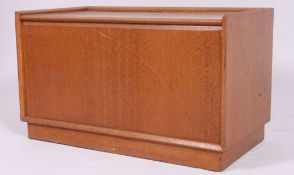 A retro 1970's teak wood window seat box having hinged lid raised on stub feet H45 W76 D41 cm