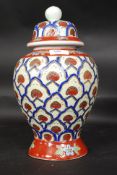 A 20th century stoneware ceramic jar, with lid. Highly decorated all over. No makers marks.