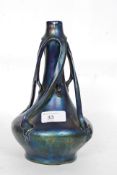 An irridescent coloured glass solifleur vase in the manner of Zsolnay Pecs of abstract form with a
