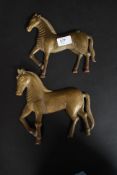An unusual near pair of 19th century hollow cast bronze horses.