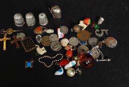 A mixed lot of jewellery - mostly charms to include some marked ' 9ct ' gold, a 9ct gold crucifix,
