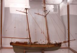 A vintage scratchbuilt model of a tall ship with single brass cannon to the deck having painted