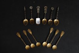 An unusual set of Indian gilded teaspoons, delicately decorated with a figure to the top,