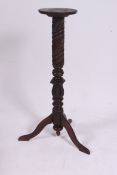 A Victorian carved oak plant stand / torchere.