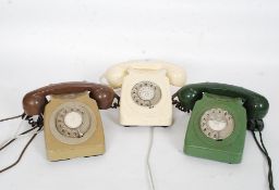 A collection of three vintage GPO telephones each in a different colour