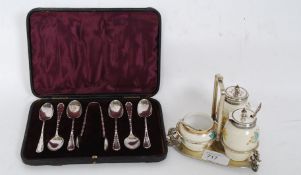 A cased set of teaspoons with faux bamboo spoons along with a ceramic condiment set on silver plate