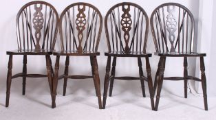 A set of 4 20th century Windsor wheelback dining chairs with turned legs having panel seats and