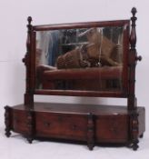 A mid 19th century mahogany swing / toilet mirror having a three drawer base raised on column
