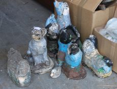 A collection of well weathered reconstituted gnomes and other garden ornaments