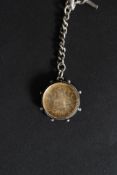 A silver hallmarked Albert chain having coin and enamel set pendant with hallmarked sides.