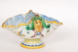 A believed 19th century Italian Cantigalli majolica raised scallop dish being decorated with