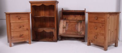 A pair of 20th century bedside cabinets of pine construction with knob handles together with a pine