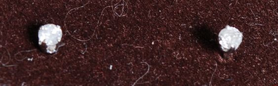 Fabulous ladies white gold diamond stud earrings presented on a baize pad