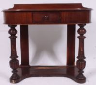 A Victorian mahogany Duchess style writing table desk of shaped form raised on turned legs with