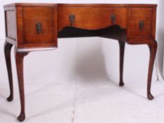 A 1940's oak Queen Anne revival writing table desk raised on cabriole legs with pad feet having a
