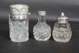 A collection of 3x hallmarked silver topped perfume bottles / condiment shakers.