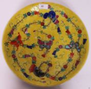 A Chinese famille juane large bowl having yellow ground with butterflies and floral swags.