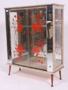 A 1950's retro formica and mirror glass display cabinet of colourful form with shelves to centre