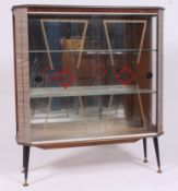 A vintage 1950's Formica retro display cabinet raised on tapering supports with decorative glass