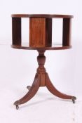 A Regency style revolving drum bookcase table having inset leather scribe to top,