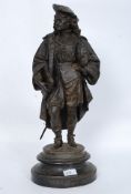 A 19th century Victorian cast metal bronzed figurine model of a scholar being raised on socle