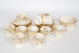 An early 20th century Ivory blush and chintz pattern part tea service comprising cups,