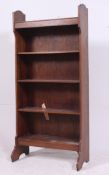 A good quality 1920's oak open window bookcase cabinet having stage gallery top with fixed central