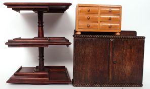 A vintage pipe rack along with a miniature chest of drawers and a revolving table top stand H30cm