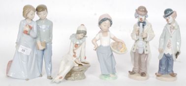 Nao / Lladro; A collection of 5x Nao / Lladro figurines - to include clowns,