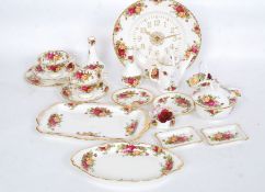 A collection of Royal Albert Country Roses to include clock, trio's,
