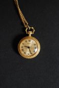 A decorative yellow metal ladies fob watch and chain by Norma having 17 jewel movement in chase