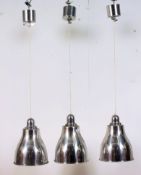 A set of three contemporary retro style chrome / polished steel finish rise and fall pendant light