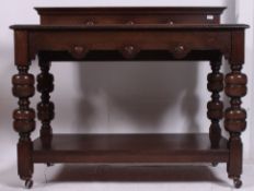A Victorian style large jacobean revival oak buffet / sideboard dresser raised on cup and cover