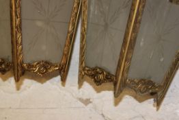 A pair of 20th century rococo gilded metal etched glass hanging light shade lanterns having frosted