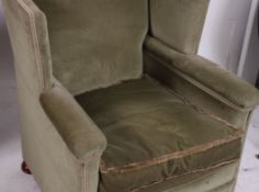 A good quality knoll style early 20th century armchair being upholstered in green velour with rope
