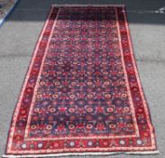 A 20th century rug / runner having geometric patterns and boarders too edge