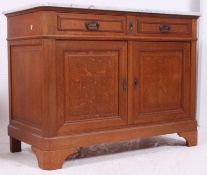 A 1930's French oak and marble sideboard featuring a solid oak base with double door cupboard and
