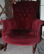 A Victorian style mahogany button back armchair.