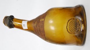 A vintage old champagne bottle with imperfections to the galas with an old label to centre having