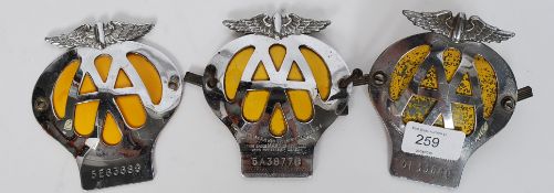 A collection of 3 vintage cast metal AA car badges two with full fittings