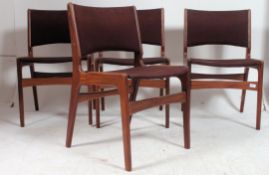 A set of 4 1970's retro vintage teak dining chairs having tapered supports with pad seats in the