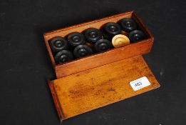 An early 20th century mahogany cased box wood set of draughts in boxwood and ebony ( see