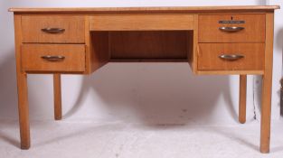 A 1950's air ministry style oak office writing table desk with central kneehole recess flanked by