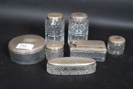 A cut glass seven piece dressing table set all having silver hallmarked lids with date letter for