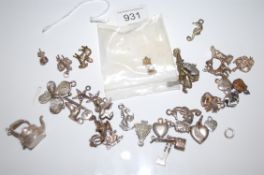 A large selection of silver charms together with a 9ct charm of an owl. Total Weight 52.