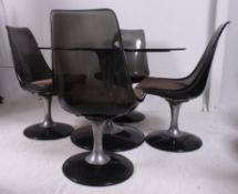 A 1970's retro smoked glass and chrome dining table together with a matching set of smoked acrylic