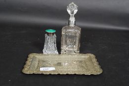 An Indian silver white metal small pin tray decorated with traditional Indian scenes,