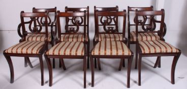 A set of 8 mahogany Regency brass inlaid lyre back dining chairs raised on sabre supports with drop