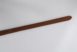 An unusual African wooden and cast iron tribal spear having tapered ends with shaped iron centre